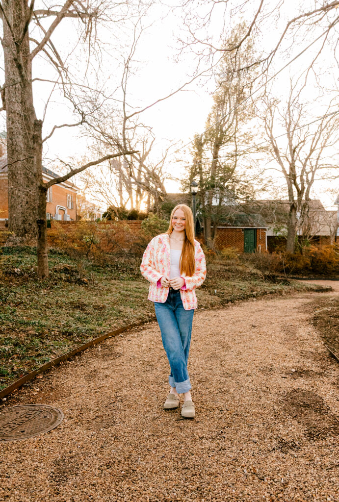 High school junior posing in a charming small town during golden hour for a Class of 2027 senior photo session.
